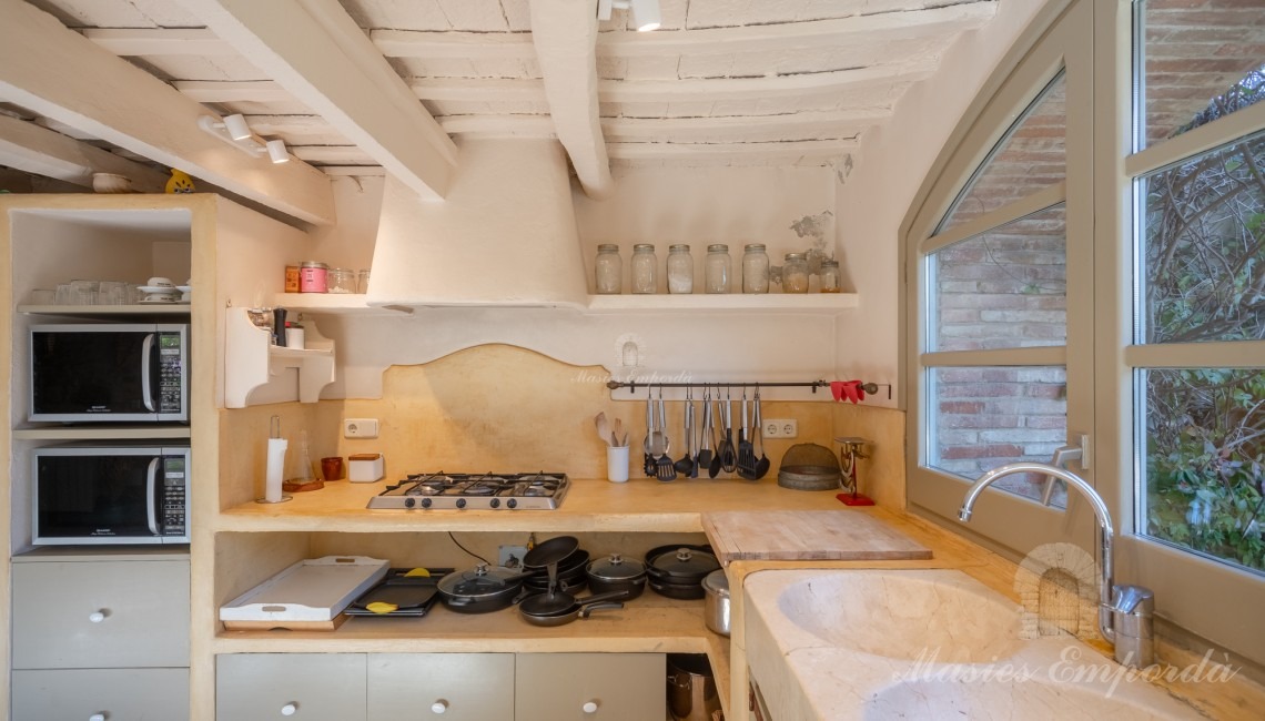 Cocina con vistas al jardín y piscina